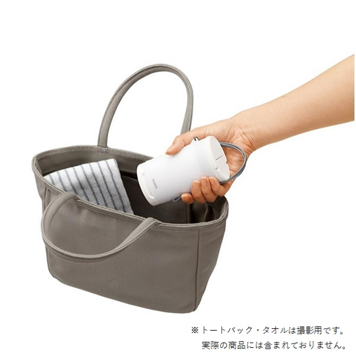 White TOTO portable Travel WASHLET with its spray wand extended